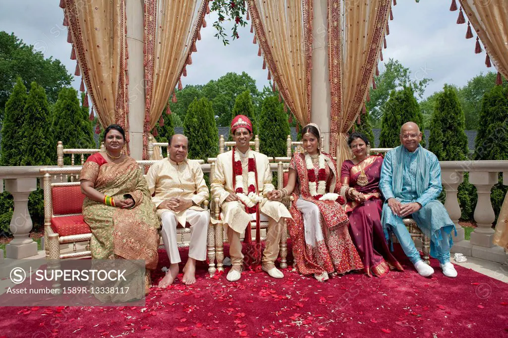 Indian bride and groom with family in traditional clothing