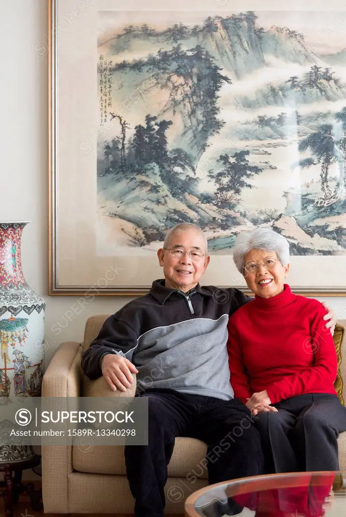 Chinese couple sitting on sofa