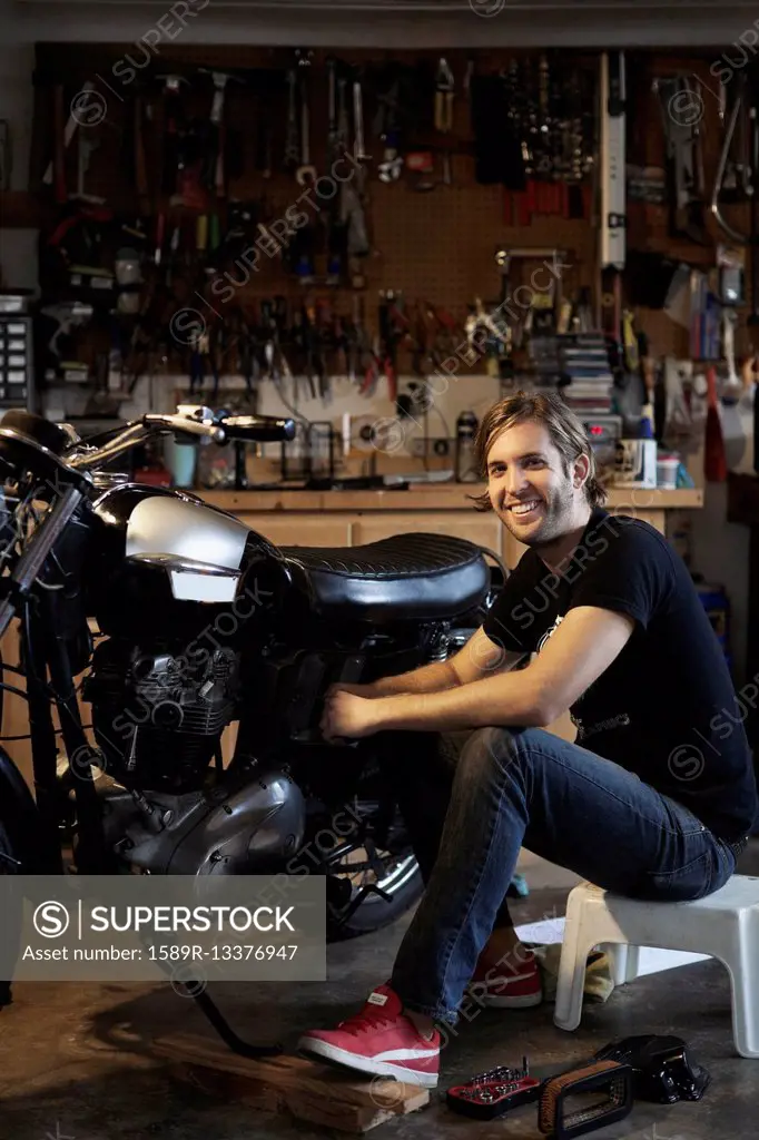 Caucasian mechanic working on motorcycle