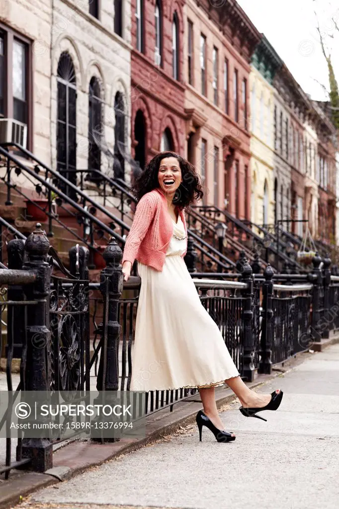 Mixed race woman smiling on city street