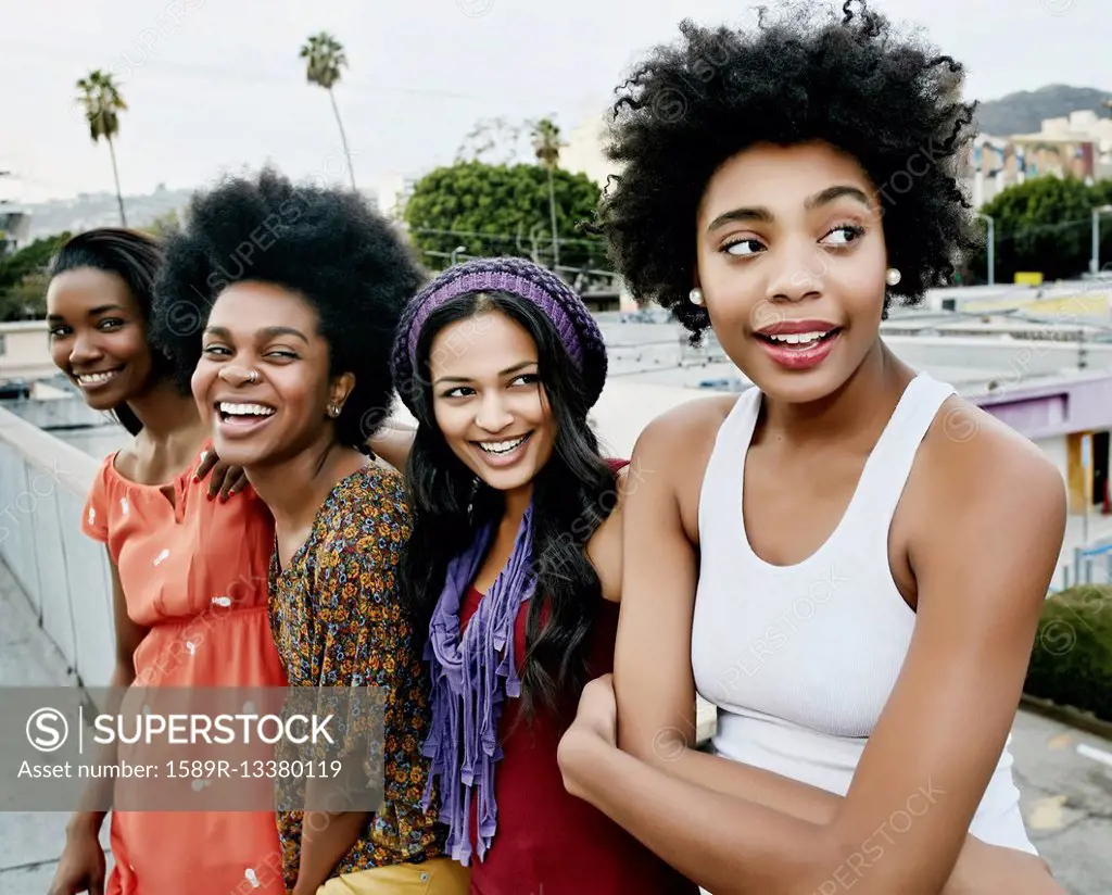 Women smiling on urban rooftop