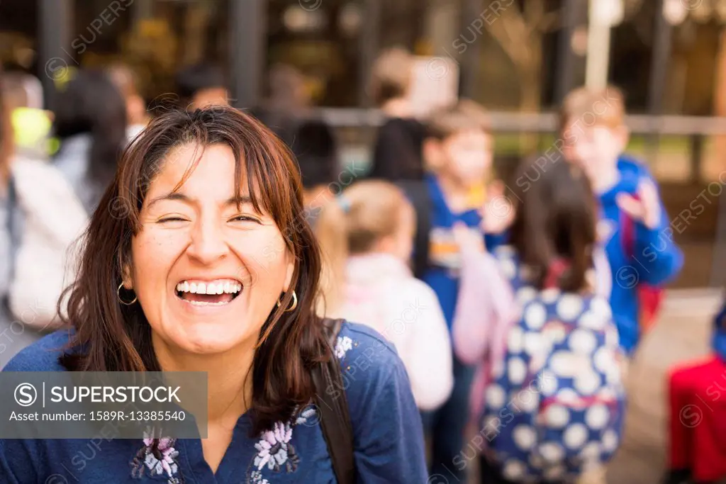 Hispanic woman laughing outdoors