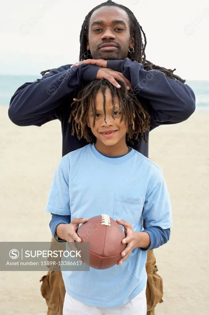 African father and son with football