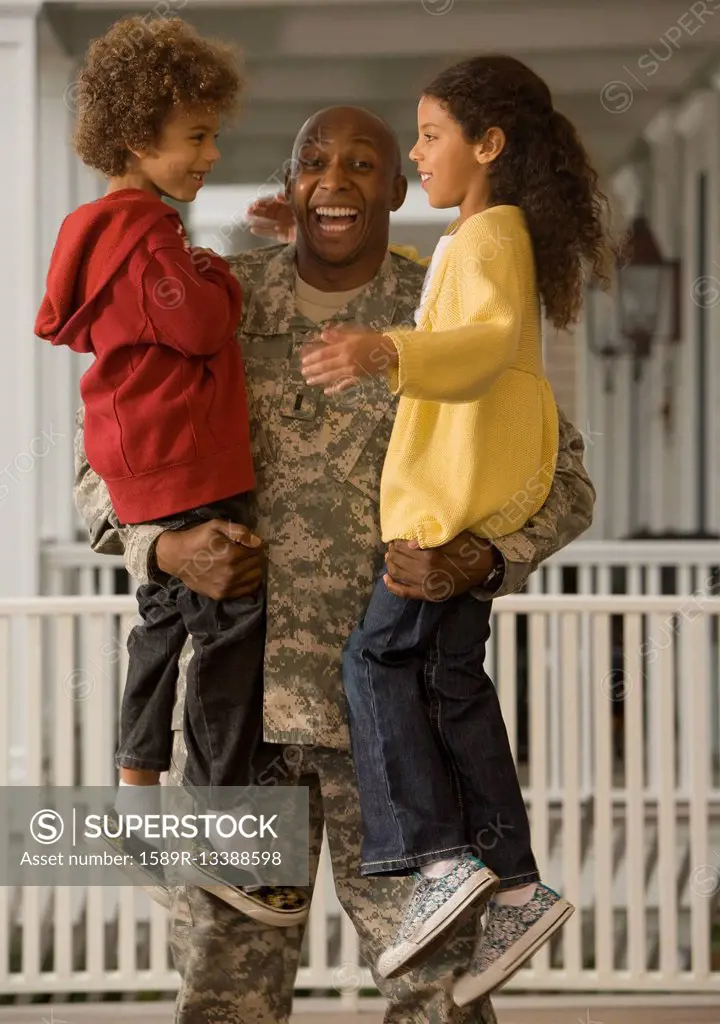 African soldier holding son and daughter