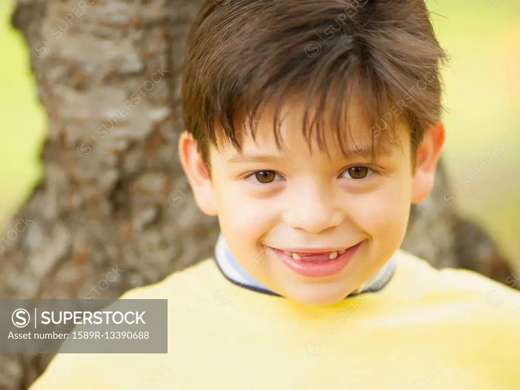 Toothless Hispanic boy smiling