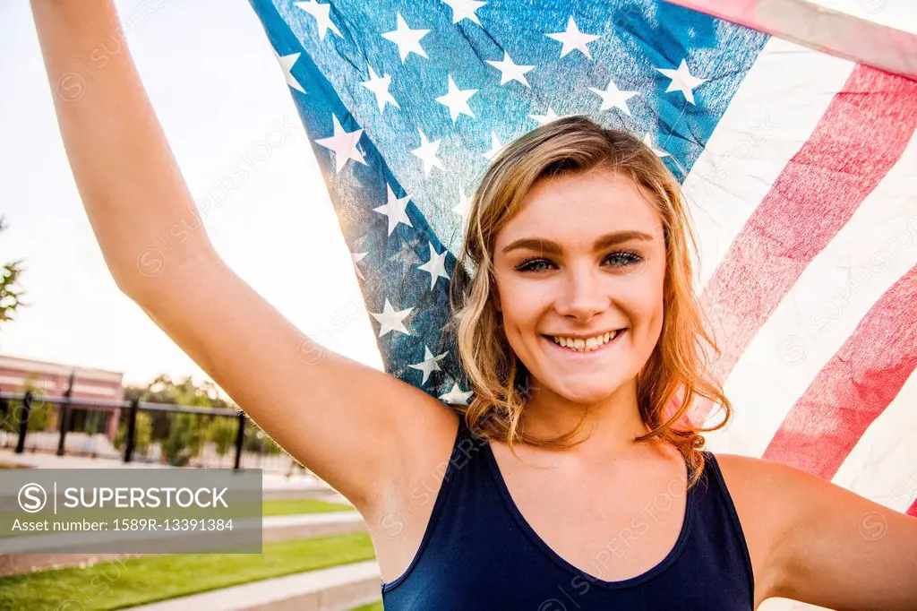 Caucasian teenage girl holding American flag