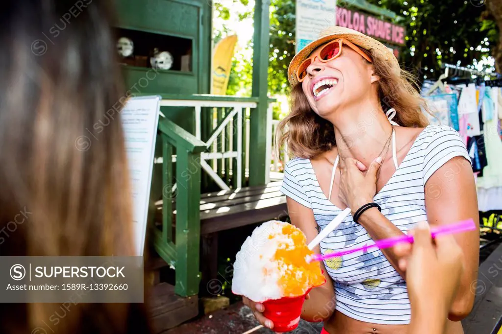 Laughing woman eating shaved ice