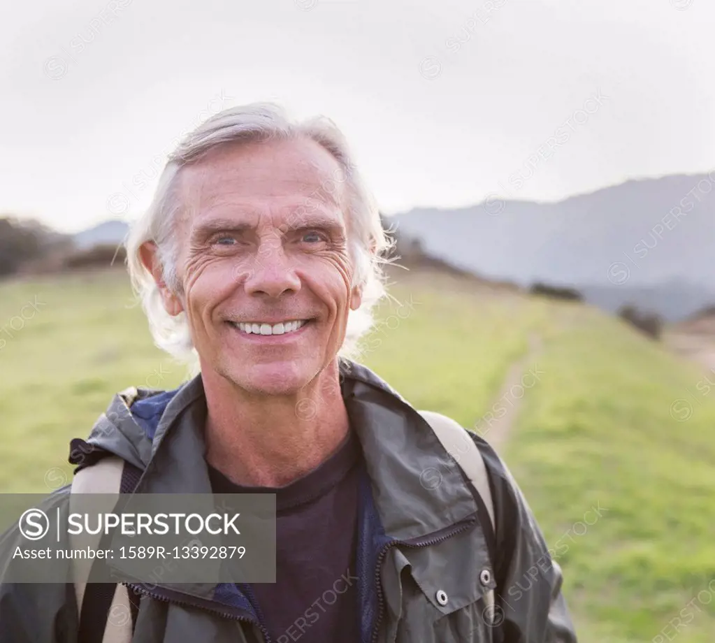 Older Caucasian man walking on dirt trail