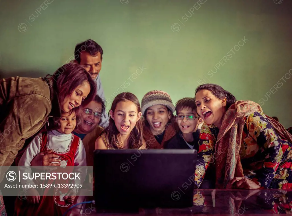 Multi-generation family videochatting on laptop