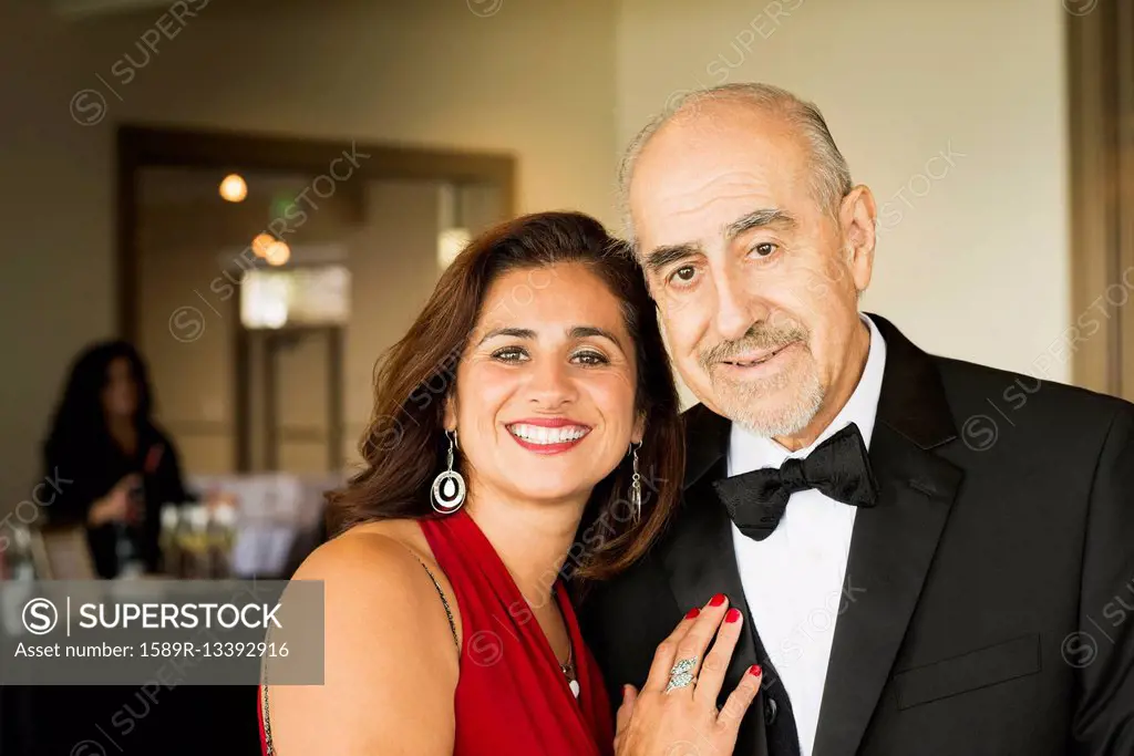 Hispanic father and daughter smiling at party