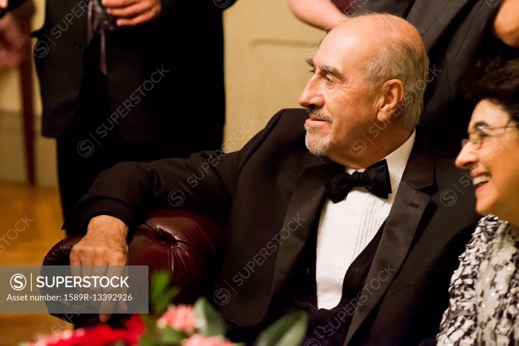 Hispanic family in formal wear sitting at wedding