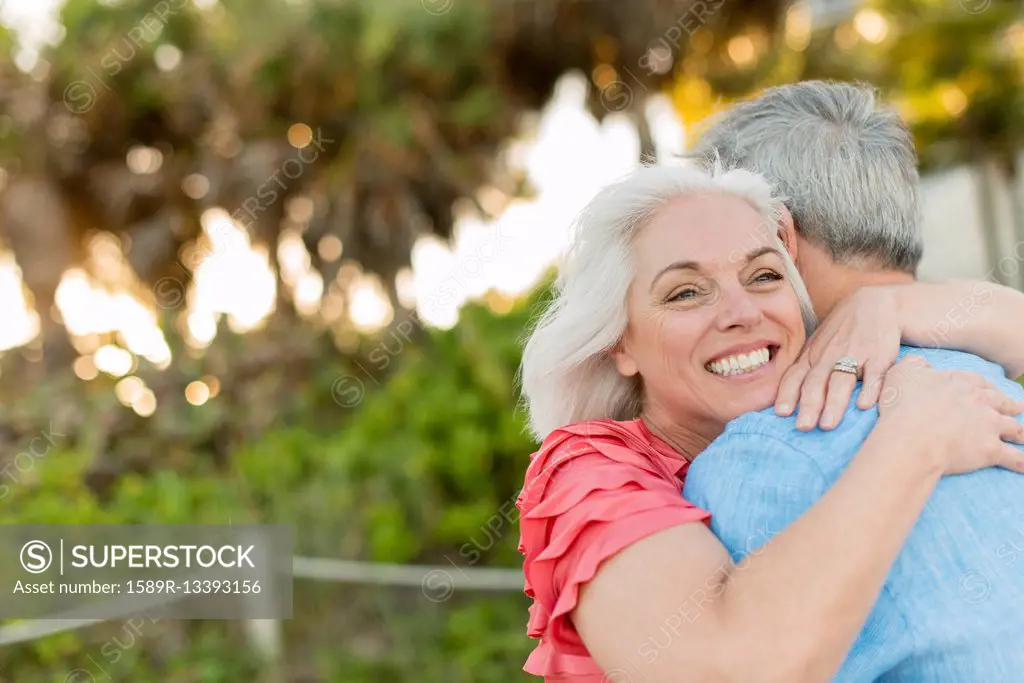 Close up of older Caucasian couple hugging