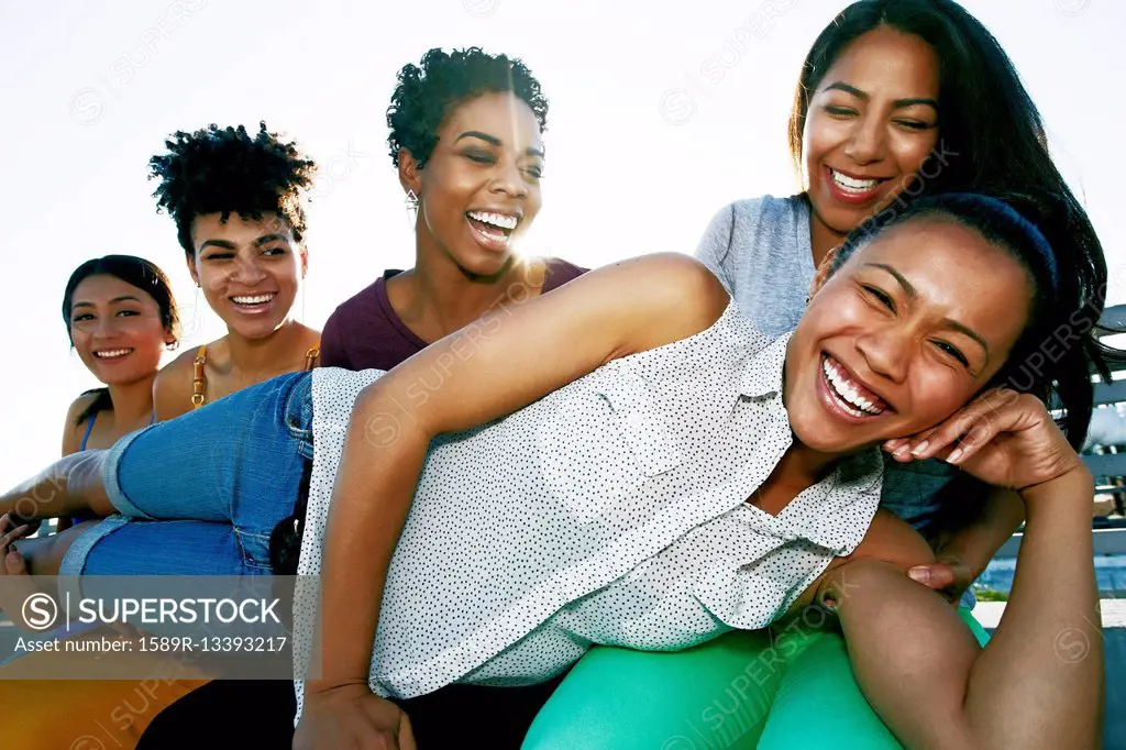 Women smiling on urban rooftop