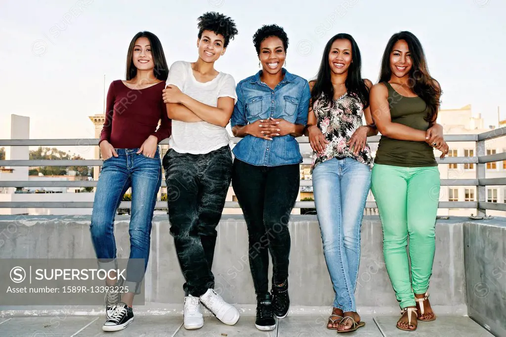 Smiling women standing on urban rooftop