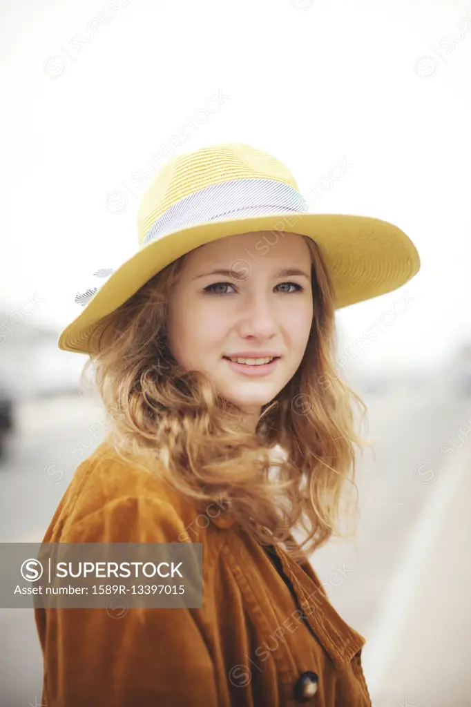 Caucasian teenage girl wearing sun hat outdoors