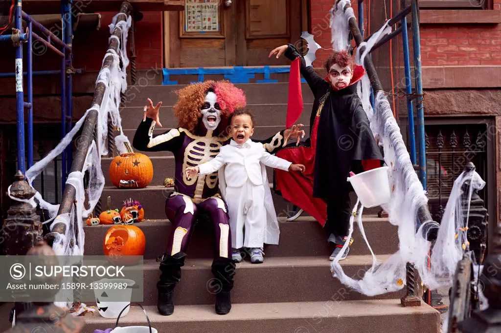 Mother and children wearing Halloween costumes