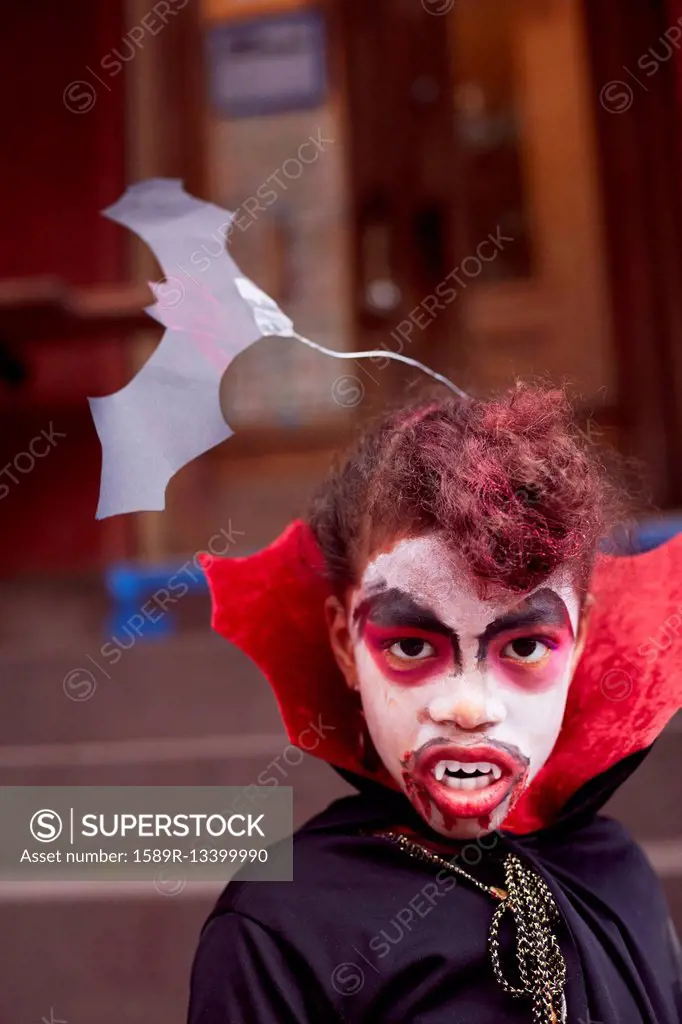 Mixed race girl wearing vampire costume