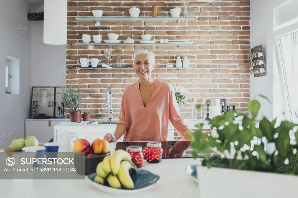 Older Caucasian woman smiling in kitchen