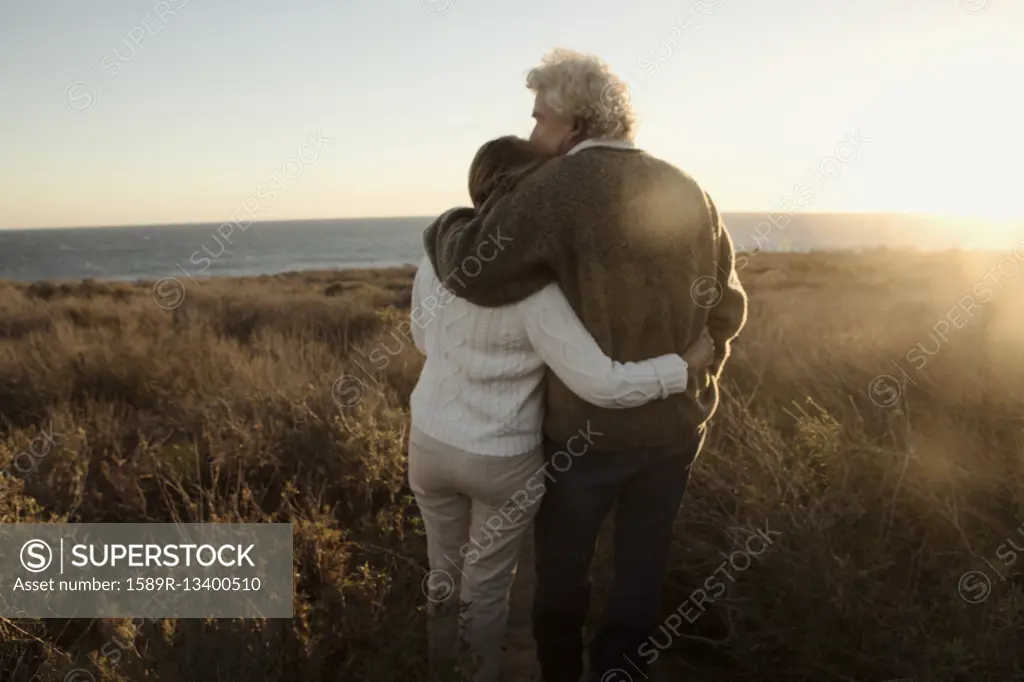 Older Caucasian couple looking at ocean view