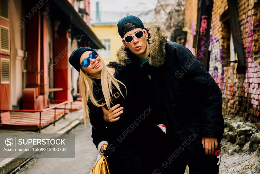 Couple hugging in urban alley