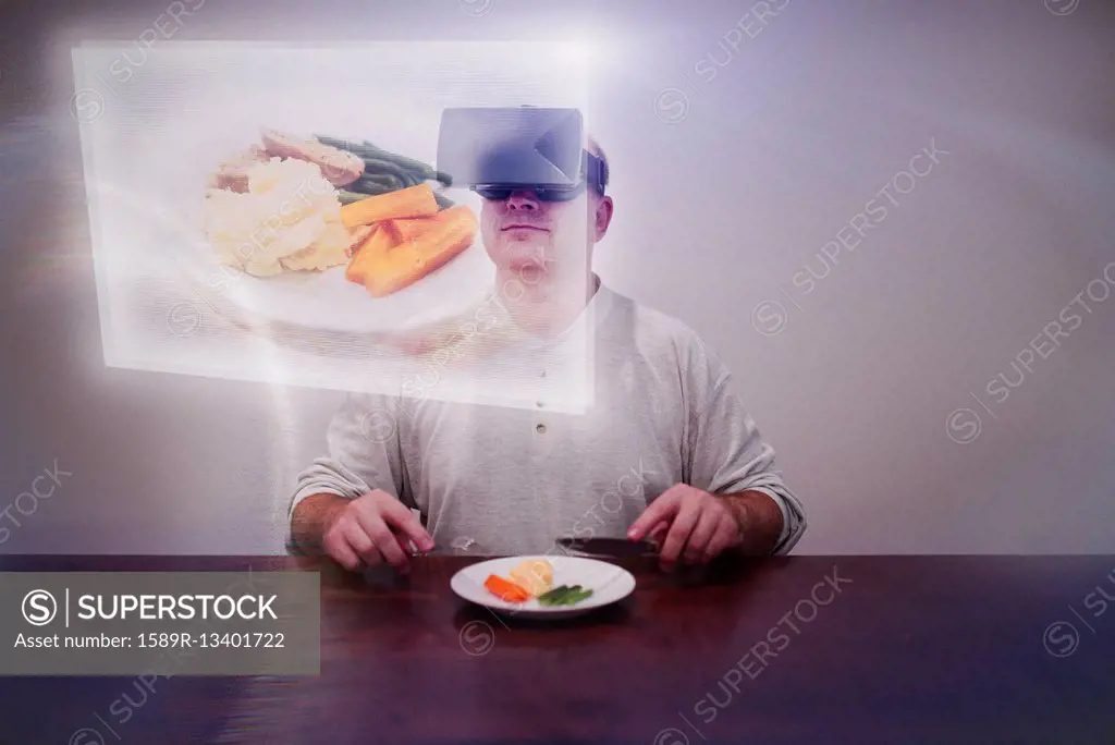 Caucasian man imagining larger meal with VR goggles