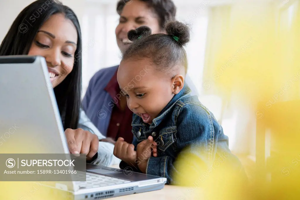 Black multi-generation family using laptop