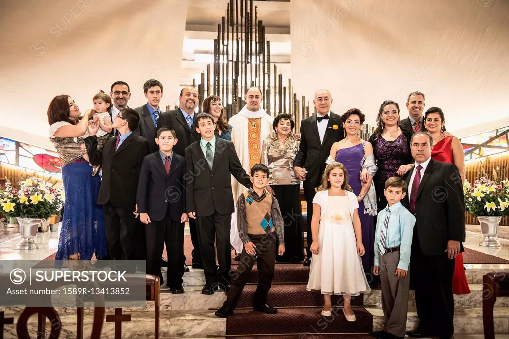 Family posing at wedding in church