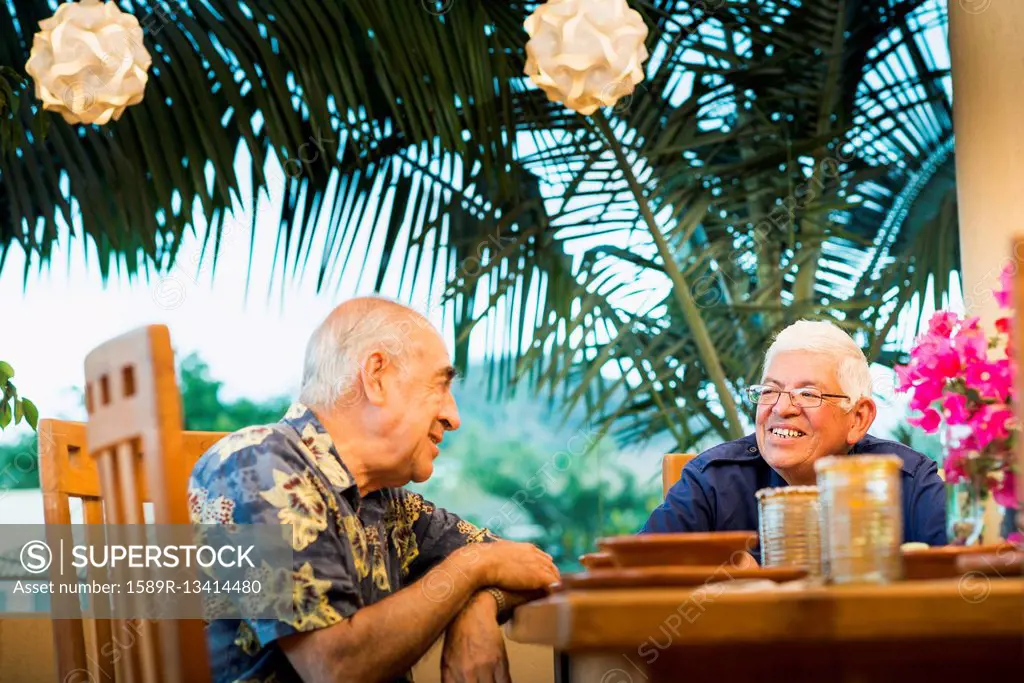 Hispanic men eating together in restaurant