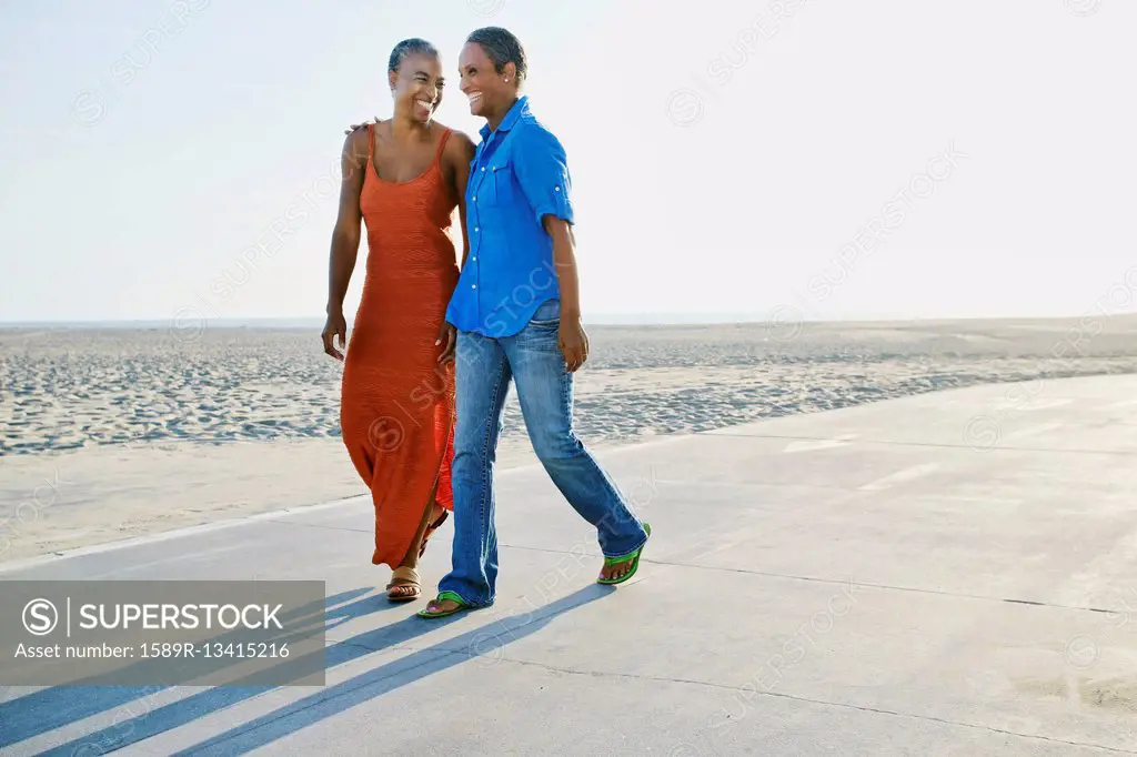 Older Black women walking by beach