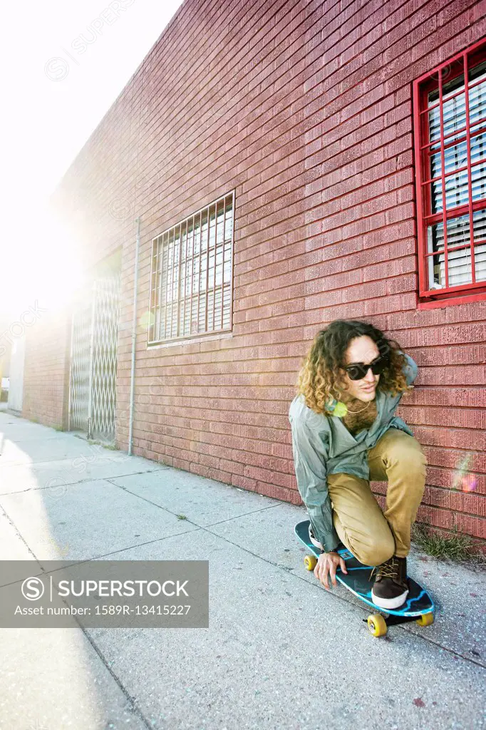 Man riding skateboard on city street