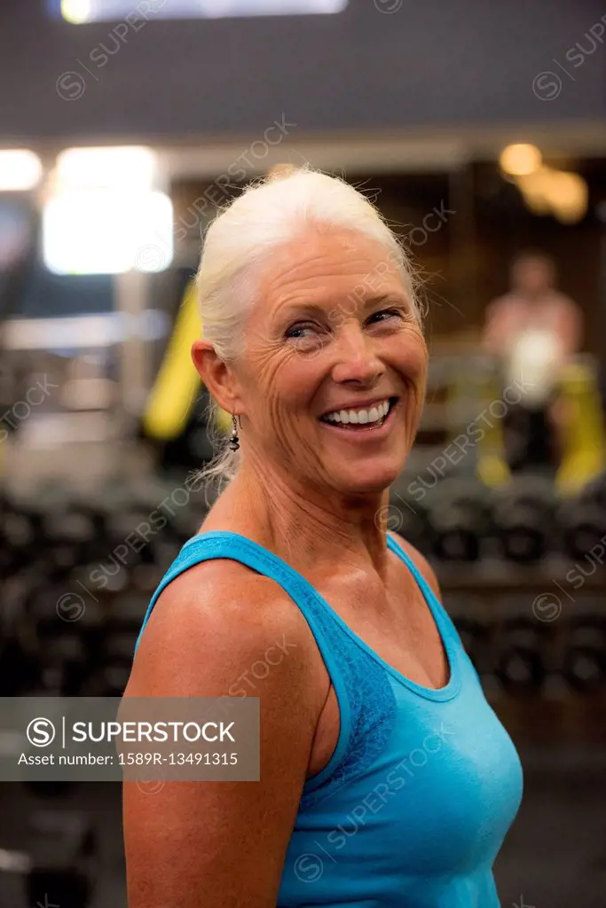 Smiling older woman working out in gymnasium