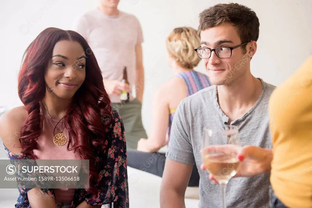 Curious couple flirting at party