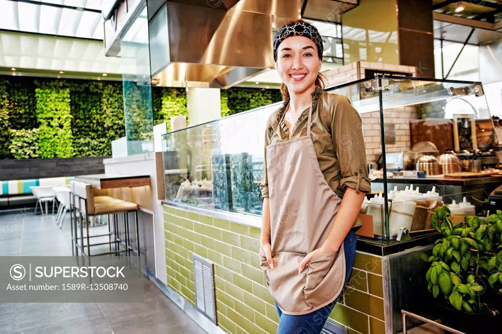 Portrait of smiling Mixed Race worker in food court