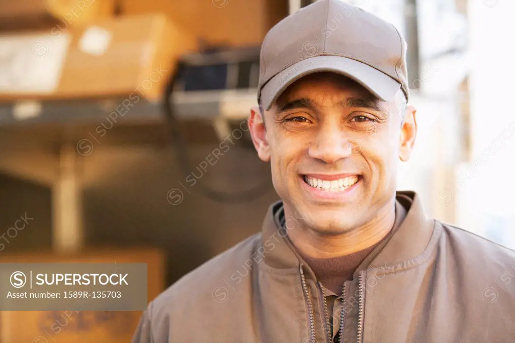 Smiling Hispanic delivery man