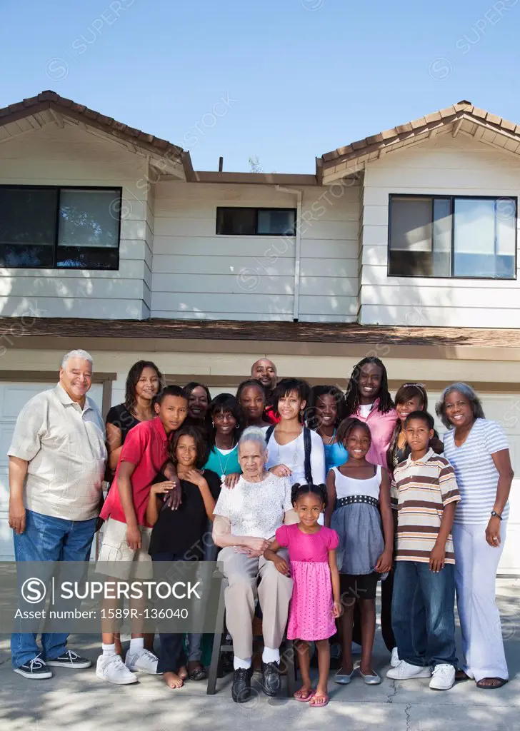 Large family standing in front of house