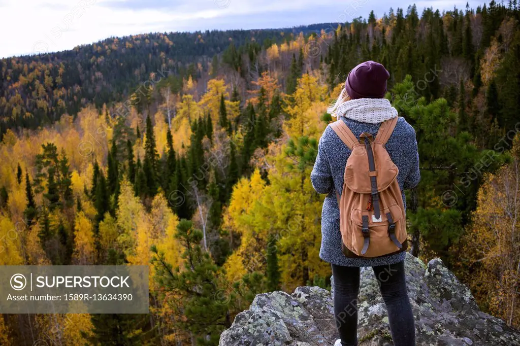 Caucasian woman backpacking in autumn landscape