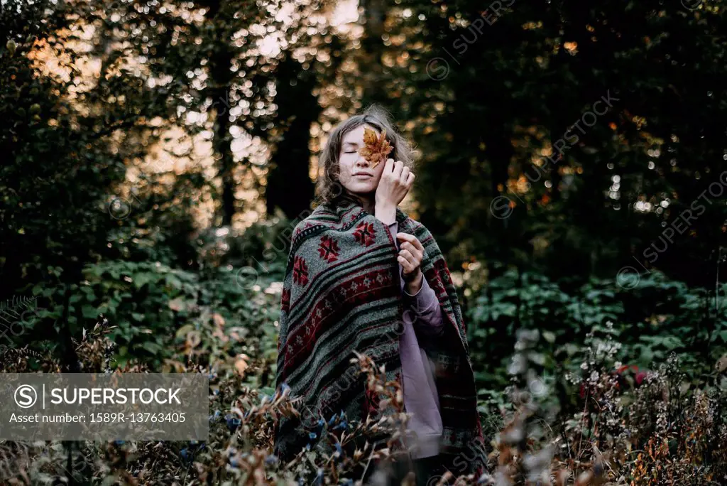 Caucasian woman holding autumn leaf