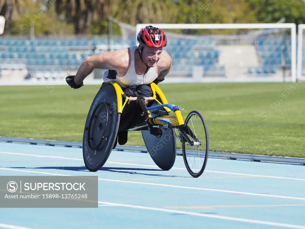 Man racing in wheelchair on track