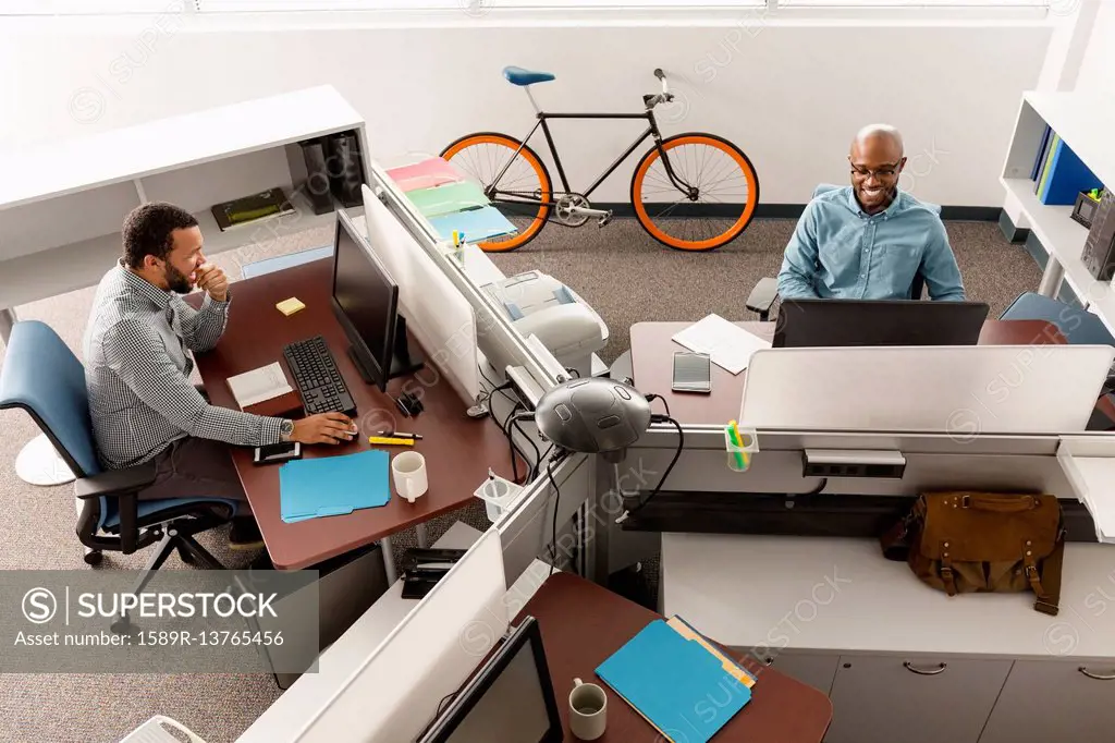 Men working at computers in office