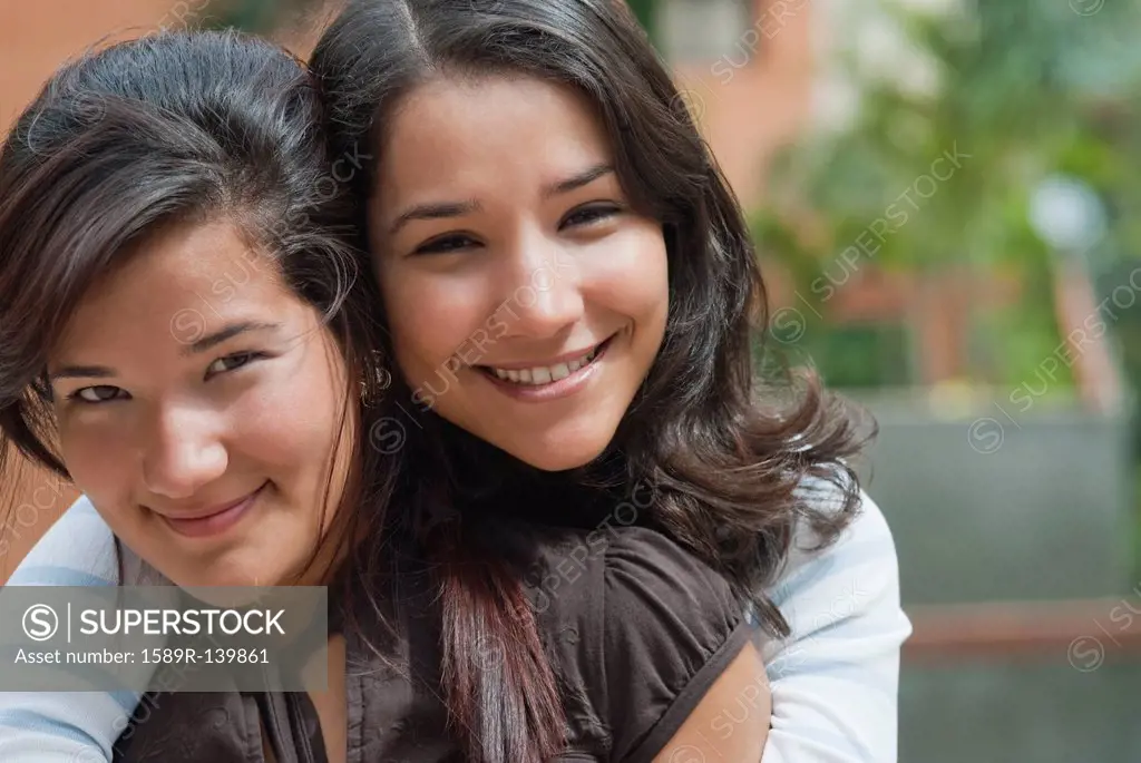 Hispanic sisters hugging