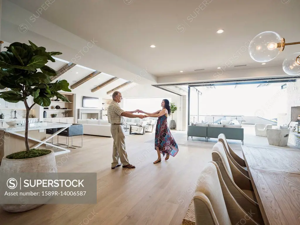 Older couple dancing in modern home