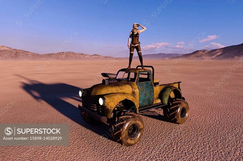 Woman on roof of truck searching in desert