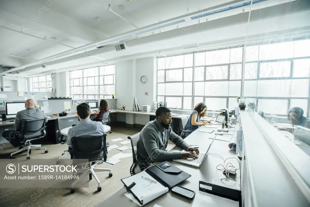 Business people working in busy office