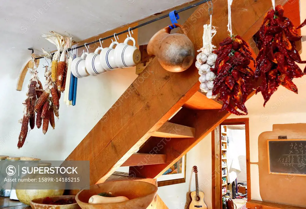 Cups and dried food hanging in traditional indigenous kitchen