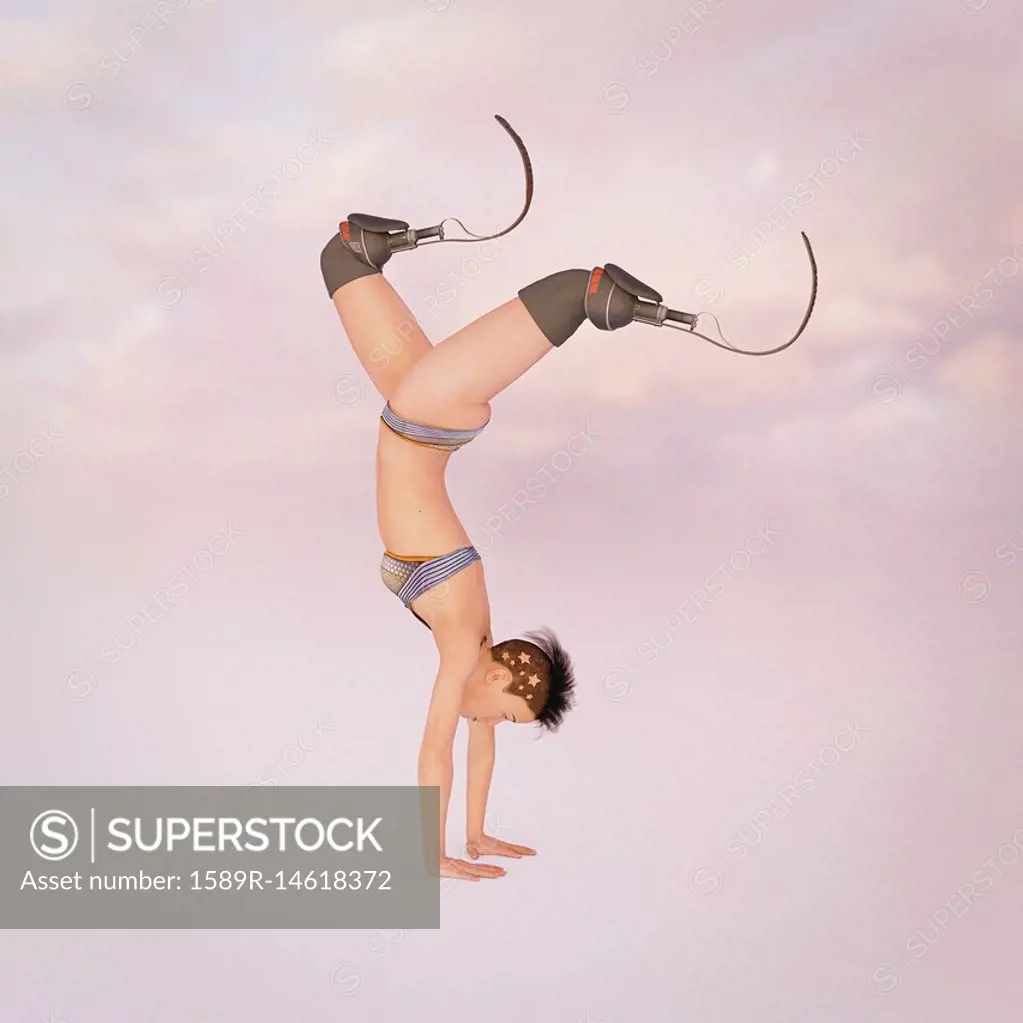 Woman with artificial legs performing handstand