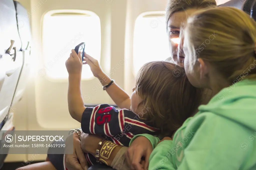 Caucasian family sitting on airplane