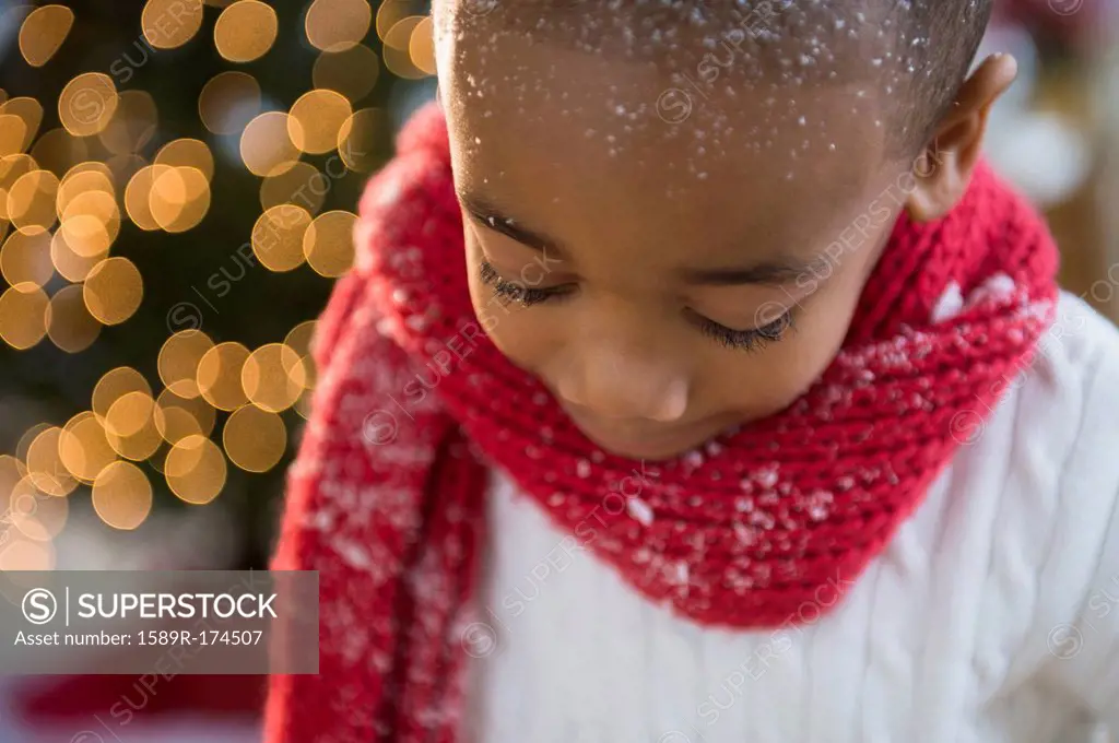 African American boy wearing scarf in snow