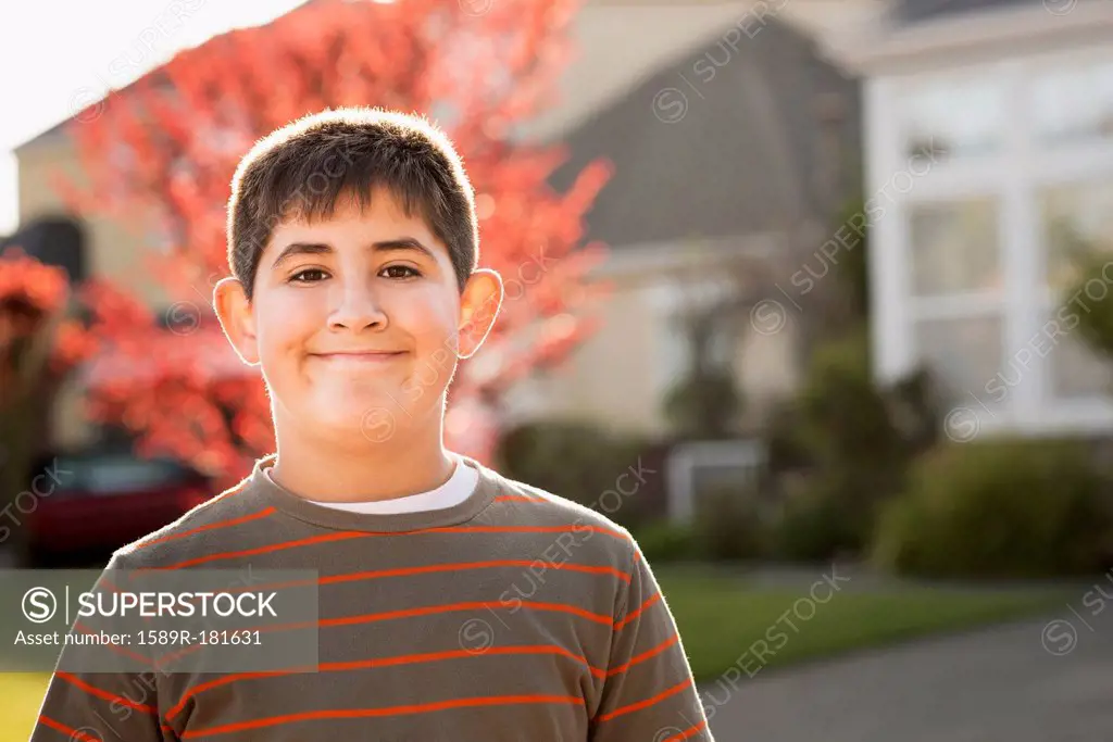 Hispanic boy smiling outdoors