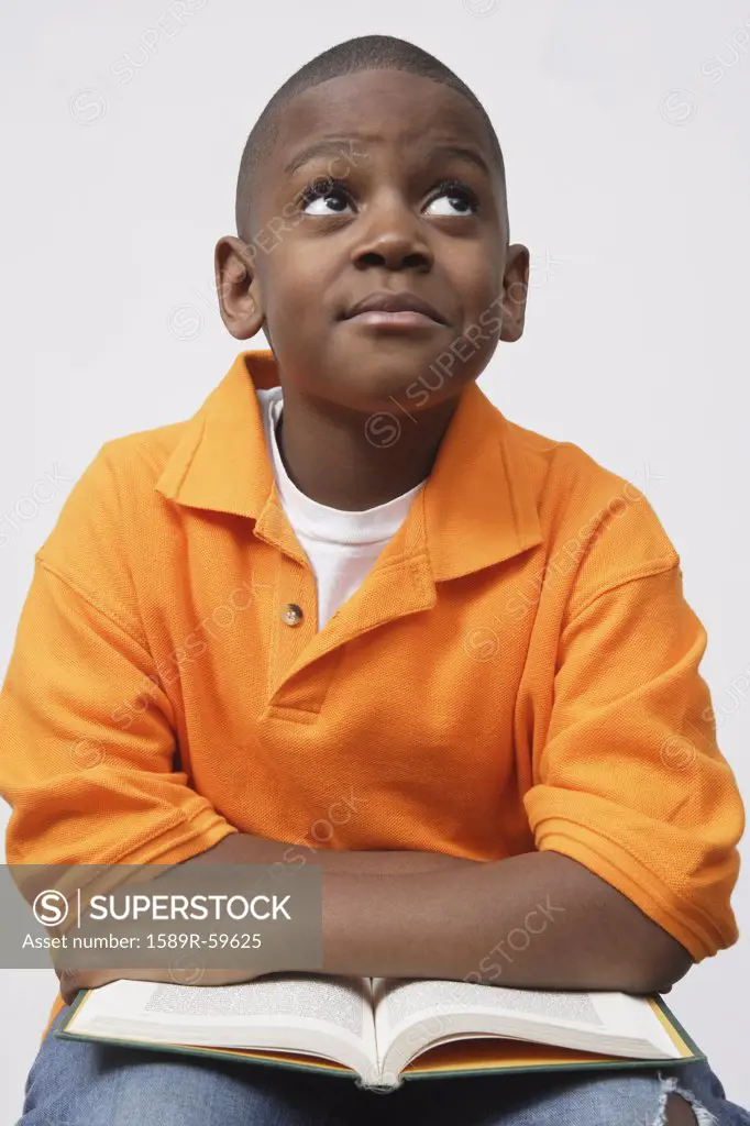 African boy holding book