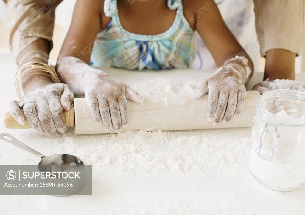 African grandmother baking with granddaughter